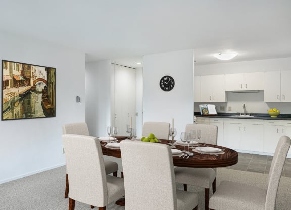 a dining room with a table and chairs and a kitchen