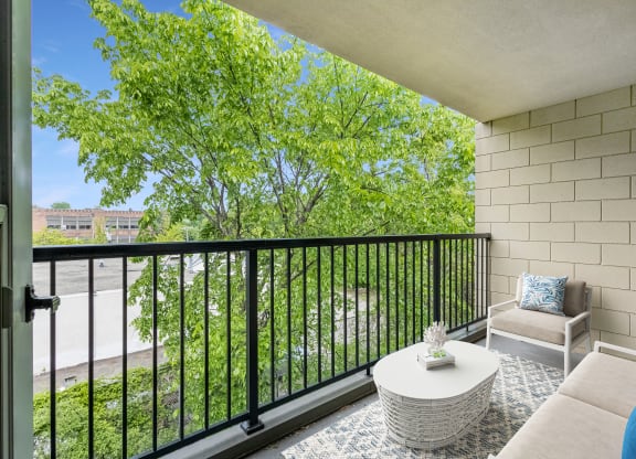 a living room with a couch and a table on a balcony
