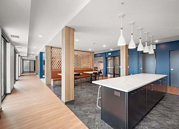 A long hallway with a kitchen area at the end. at The Landing at Amber Fields Apartments, Rosemount, MN