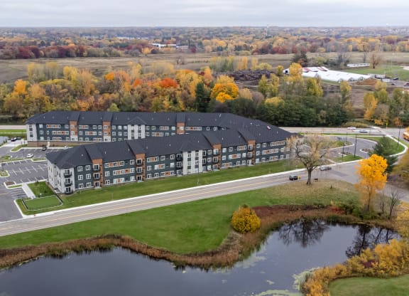 an aerial view of a Londin Crossing next to a pond
