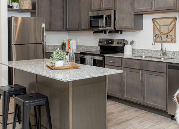 a kitchen with stainless steel appliances and granite counter tops