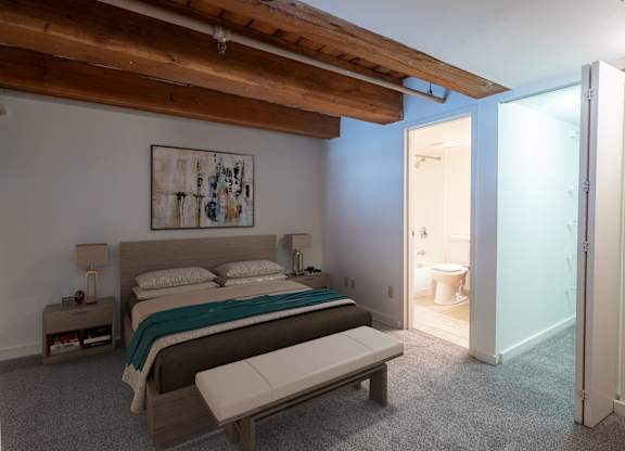 a bedroom with a bed and a bathroom