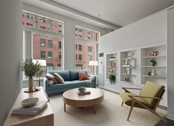 a living room with a blue couch and a round coffee table