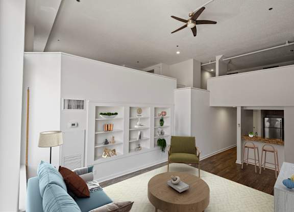 A living room with a blue couch, a green chair, a wooden coffee table, and a ceiling fan.