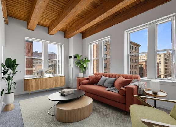 A living room with a red couch and a coffee table.