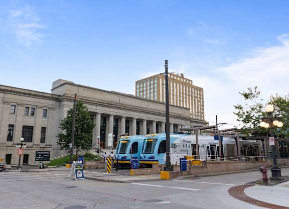 A city bus is parked at a bus stop.