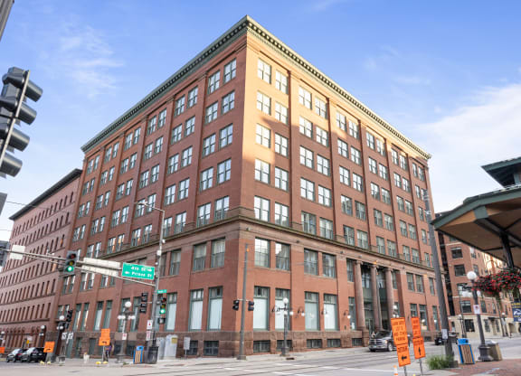 a large brick building on the corner of a city street