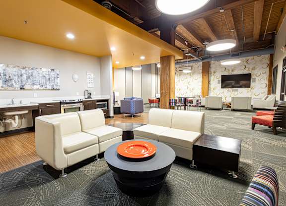 a living room with couches and chairs and a table