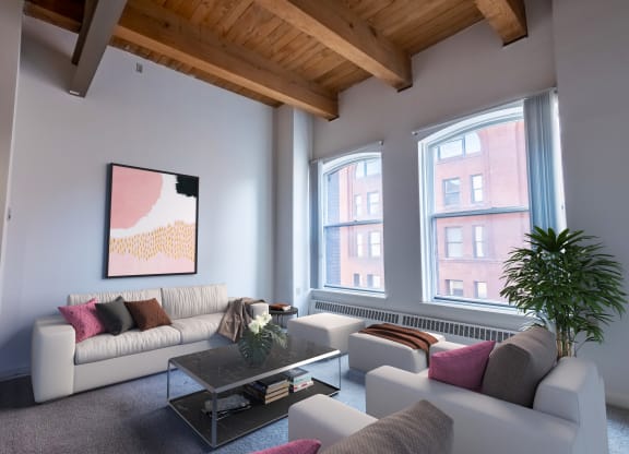 a living room with white couches and a coffee table
