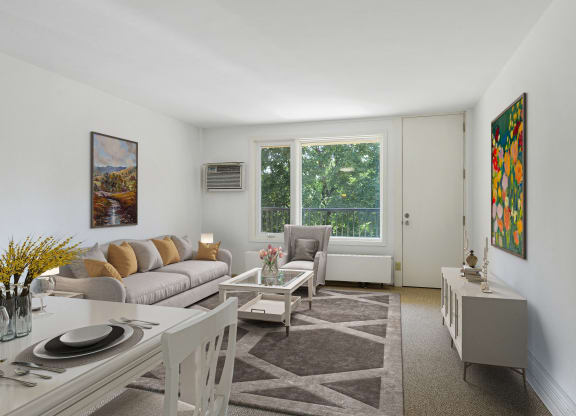 a living room with a couch and a table and a window