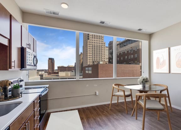 a kitchen with wooden cabinets and a view of the city