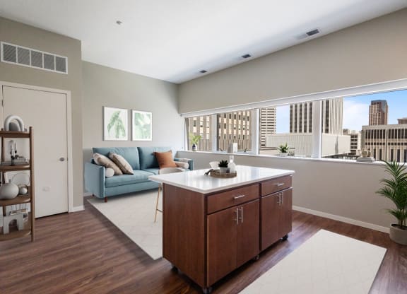 a living room with a kitchen and a large window