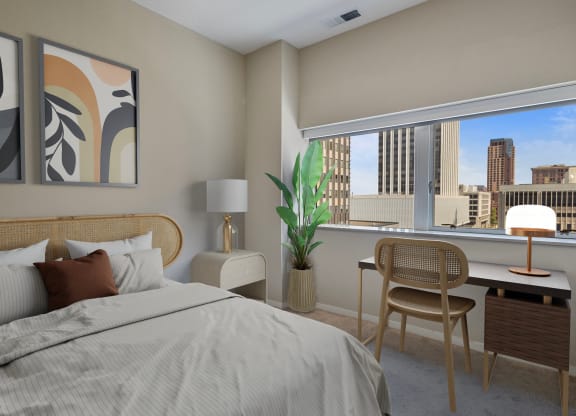 a bedroom with a bed and a desk with a window