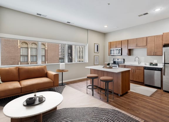 a living room with a kitchen and a couch