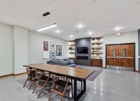 a large dining room with a wooden table and chairs