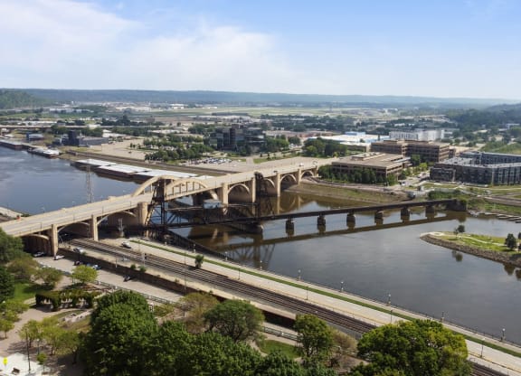 an aerial view of a bridge over a river in a city