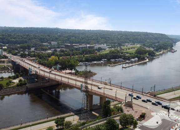 an aerial view of a bridge over a river and a city