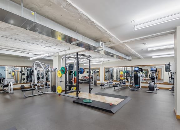 a gym with weights and other exercise equipment in a building