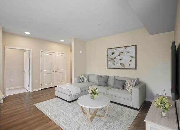 a living room with a couch and a table at The Quill 55+ Apartments, Hastings, 55033