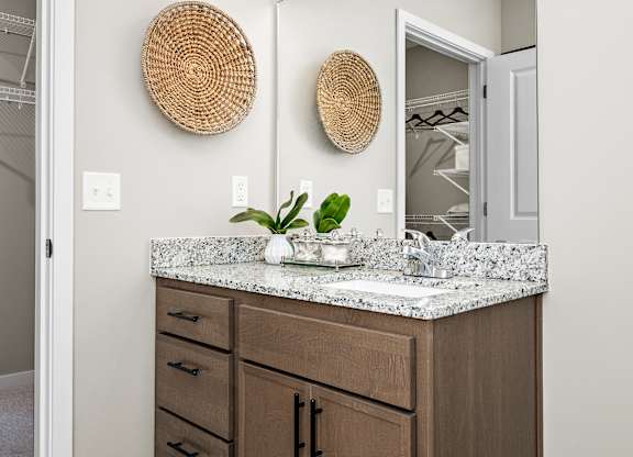 A bathroom with a vanity and a mirror.
