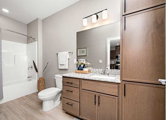 A bathroom with a toilet, sink, and shower.