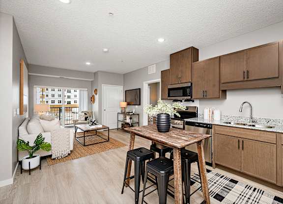 A kitchen with a table and chairs in the middle of the room.