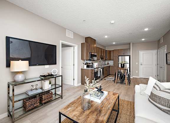A modern living room with a flat screen TV mounted on the wall.