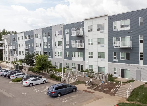 an image of an apartment building with cars parked in a parking lot at Technology Park Apartments, Rochester, 55901