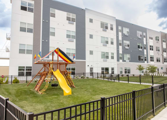 a playground in the middle of an apartment building with a slide at Technology Park Apartments, Minnesota