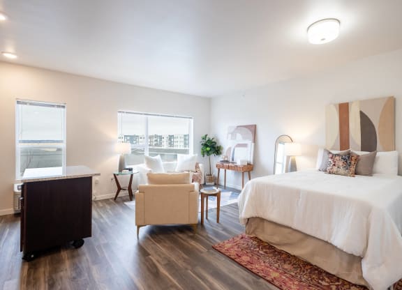 a bedroom with a bed and a desk and a chair at Technology Park Apartments, Rochester, MN, 55901