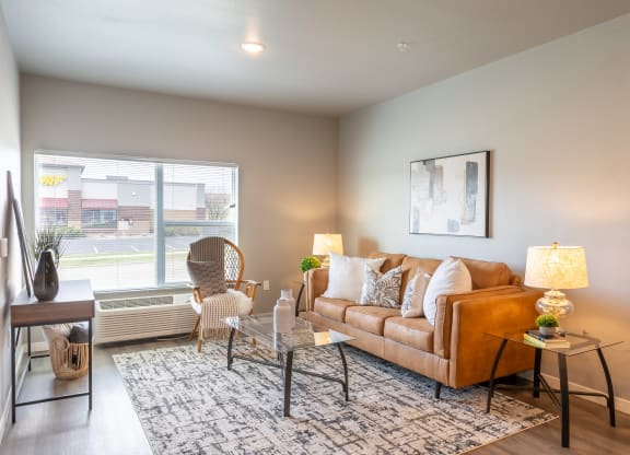 an open living room with a couch and a window at Technology Park Apartments, Minnesota, 55901