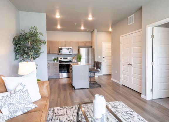a living room and kitchen with a couch and a table at Technology Park Apartments, Rochester, Minnesota