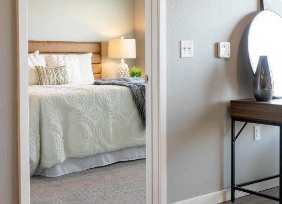 a bedroom with a bed and a nightstand and a mirror at Technology Park Apartments, Rochester