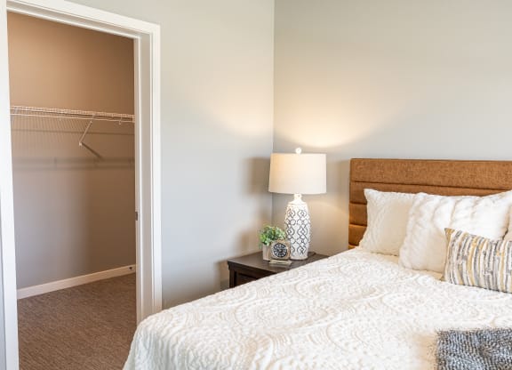 a bedroom with a bed and a closet at Technology Park Apartments, Rochester, MN