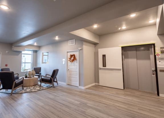 the clubhouse at the champion apartments has a living room and kitchen at Technology Park Apartments, Rochester, MN
