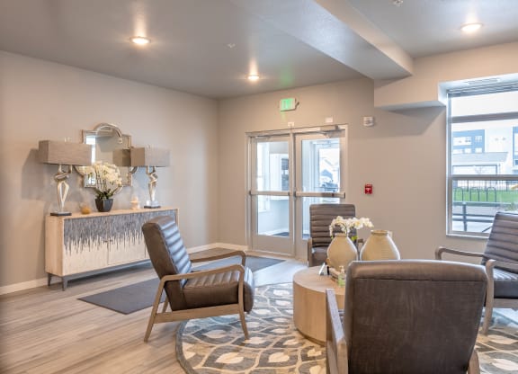 a living room with chairs and a table and a fireplace at Technology Park Apartments, Rochester, MN, 55901