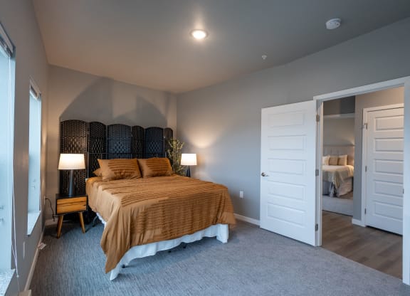 a bedroom with a bed and a door to a bathroom at Technology Park Apartments, Minnesota