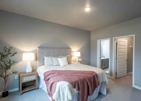 a bedroom with a large bed and a door to a bathroom at Technology Park Apartments, Rochester, Minnesota
