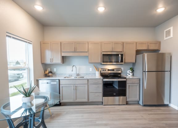 a kitchen with stainless steel appliances and white cabinets at Technology Park Apartments, Rochester, Minnesota