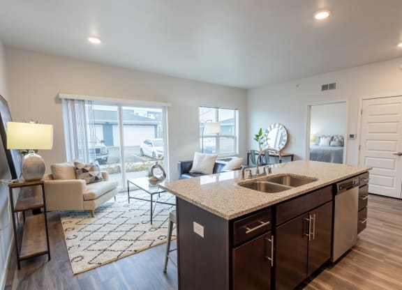 an open living room and kitchen with a view of a living room with a couch at Technology Park Apartments, Rochester