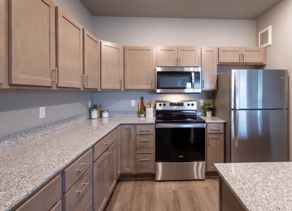 a kitchen with granite counter tops and stainless steel appliances at Technology Park Apartments, Rochester, 55901