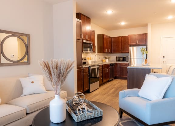 a living room and kitchen with a couch and a table