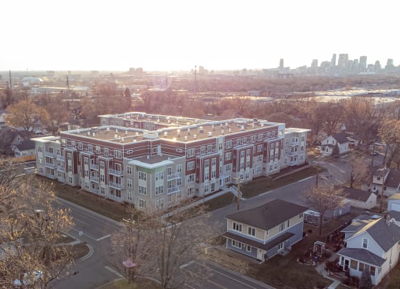 an aerial view of a large building with a city in the background