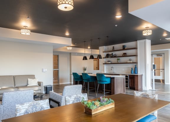 a living room and kitchen with a table and chairs