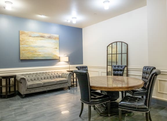 a dining room with a table and chairs and a couch