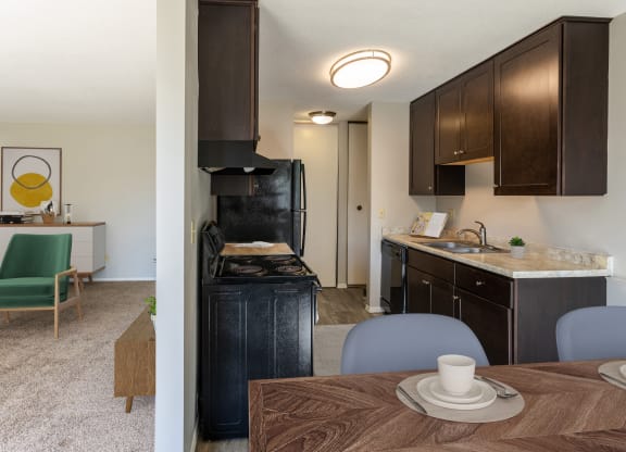 the view of a kitchen and dining room with a table and chairs