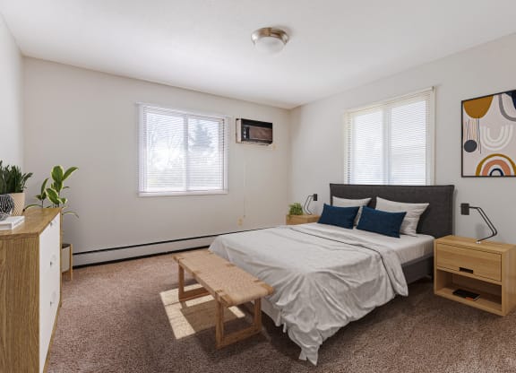 a bedroom with a bed and a dresser and two windows
