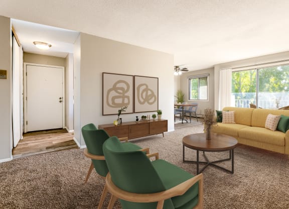 a living room with a yellow couch and green chairs