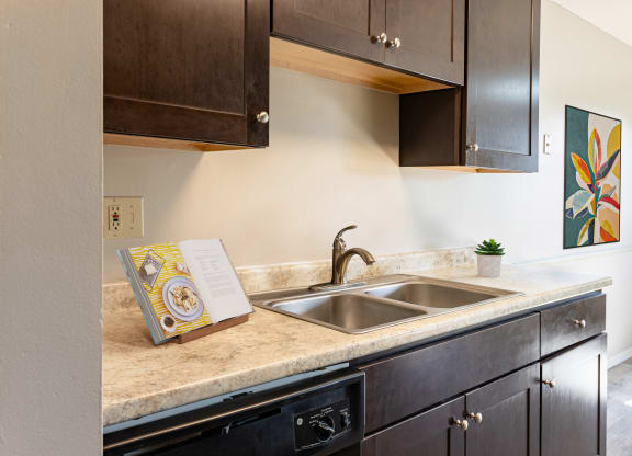 a kitchen with a sink and a book on the counter