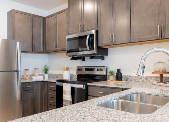 a kitchen with granite counter tops and stainless steel appliances